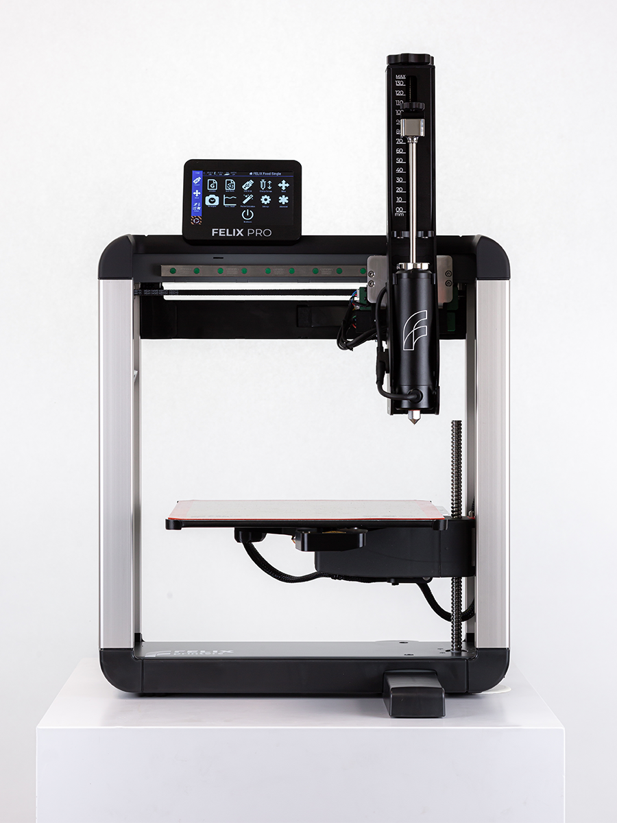 Front mid-shot Felix 3D food printer plus plastic basic syringe, compact desktop 3D food-printing setup