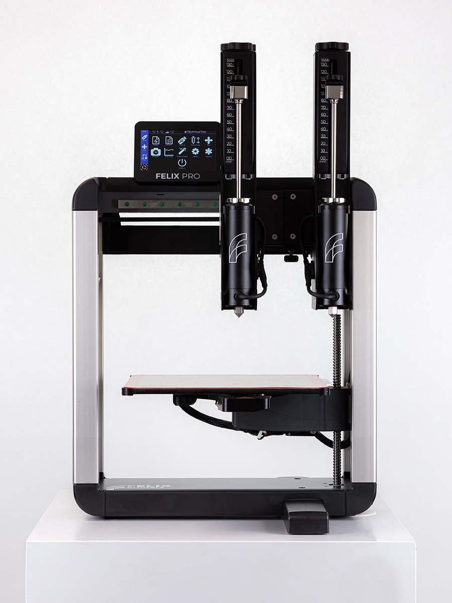 	Front mid-shot Felix TwinHead 3D food printer plus dual premium steel syringes for fast, consistent dual-object food prints