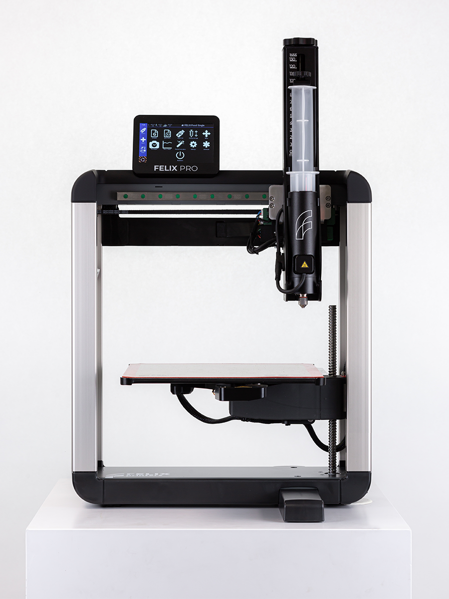 	Front mid-shot Felix 3D food printer plus stainless-steel premium syringe for fast, consistent food prints