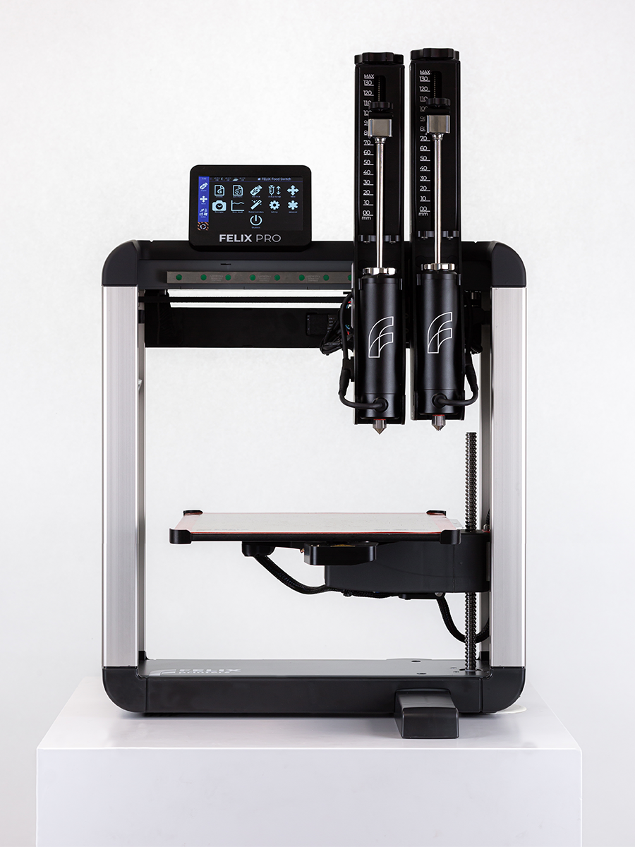 Front mid-shot Felix Switch 3D food printer plus dual stainless-steel premium syringes for fast, consistent food prints