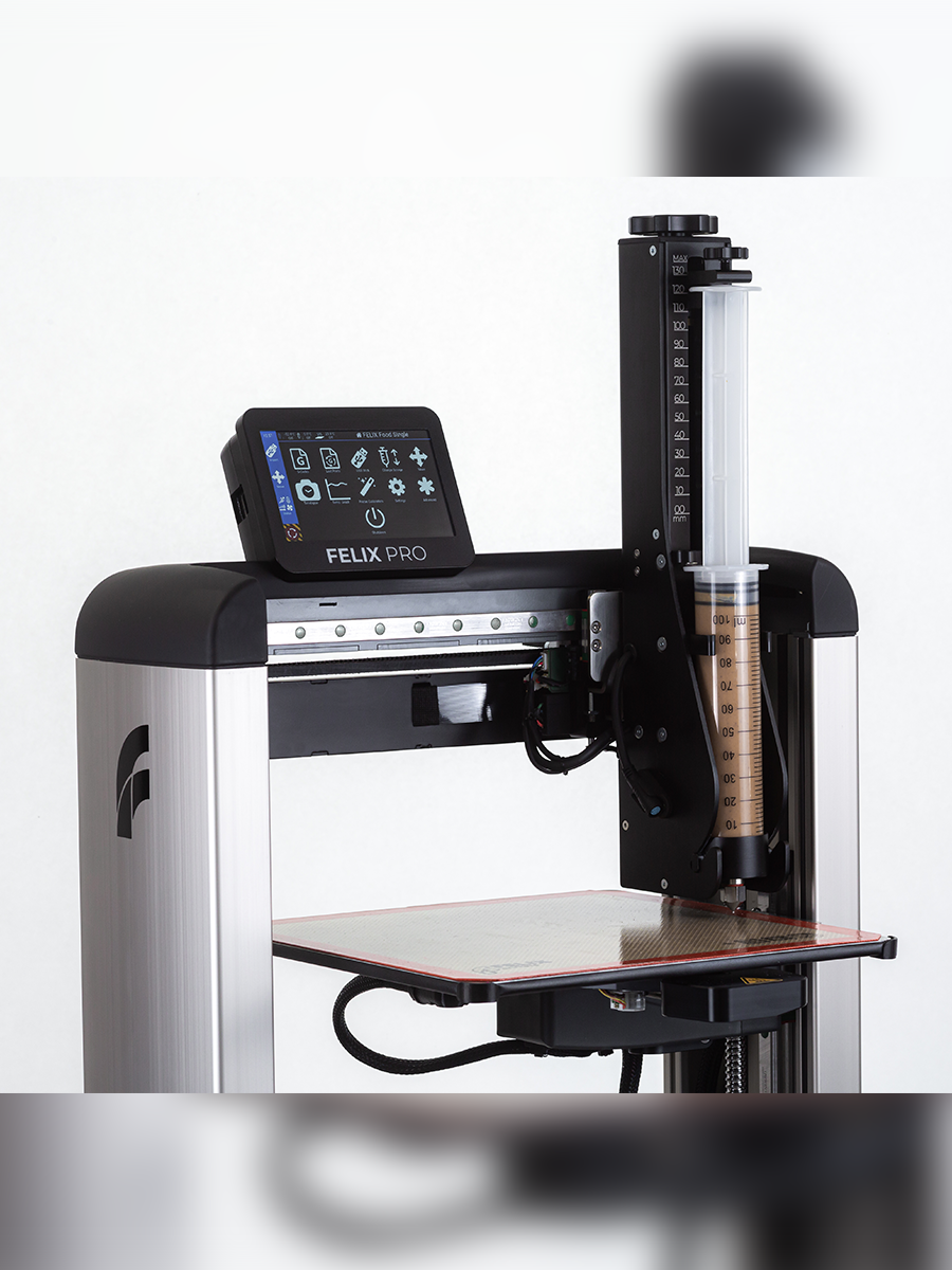 	Close-up stainless-steel premium syringe in Felix 3D food printer – durable, hygienic cartridge for food printing